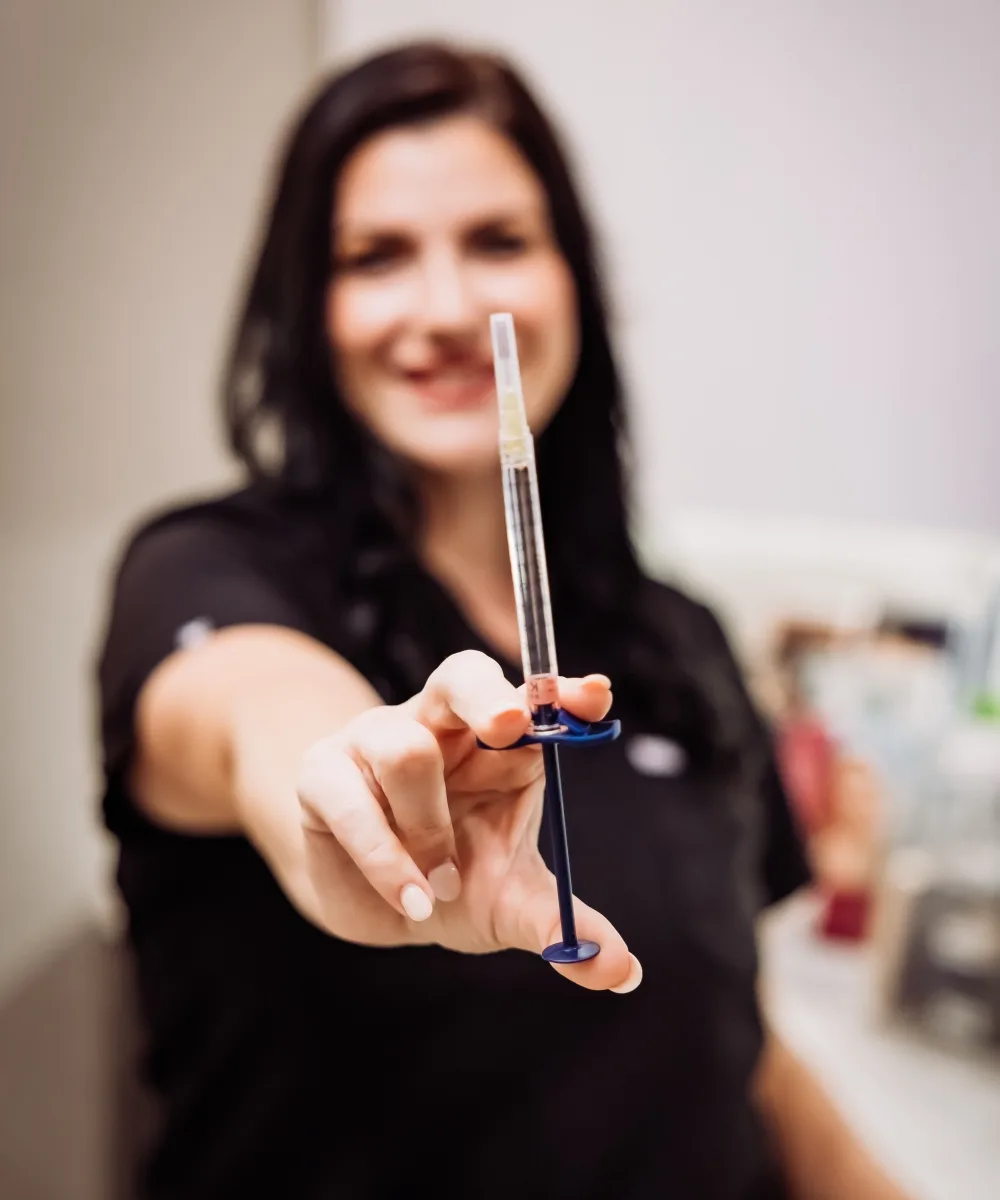 A provider at The Bluffs holding a filler syringe in a treatment room